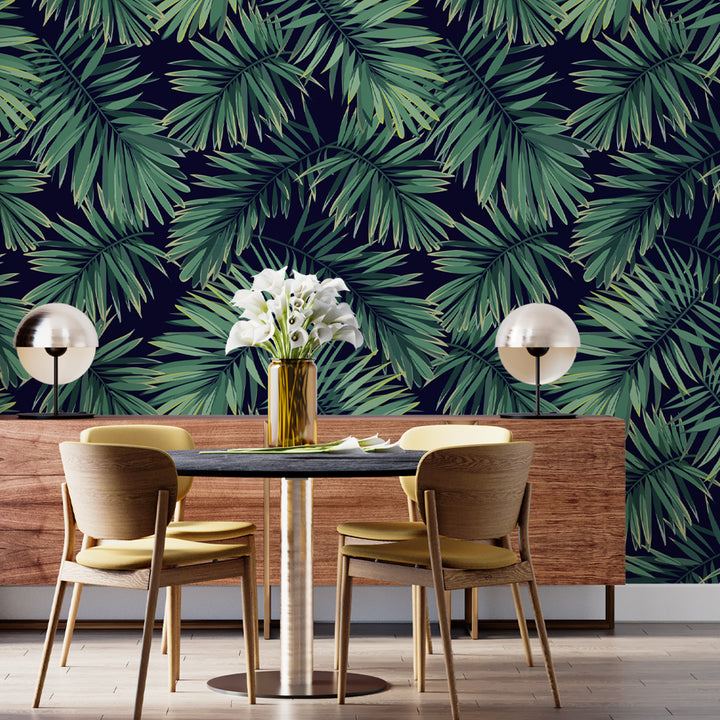 Bold tropical wallpaper mural with layered green palm fronds on dark navy, removable and renter-friendly peel and stick or pre-pasted options.