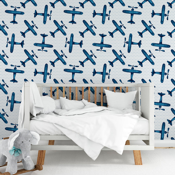 Boys airplane wallpaper pattern with hand-painted blue aircraft and tiny dots on white, ideal for aviation themed nursery or bedroom, printed on removable wallpaper panels.