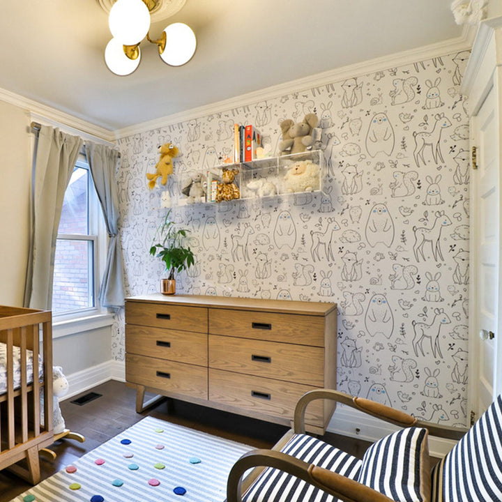 Cute animal wallpaper for baby room featuring foxes, owls, deer, squirrels, and bears drawn in Scandinavian style, removable peel-and-stick or pre-pasted for clean, damage-free installation on lightly textured walls.