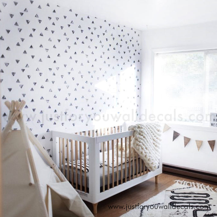 Contemporary geometric wallpaper design with small, modern black triangles in a random pattern., black and white nursery wallpaper