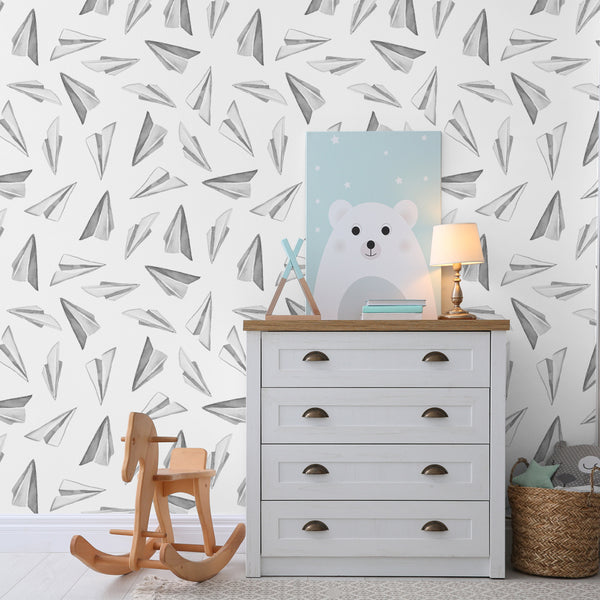 Black and white paper airplane wallpaper featuring hand-painted watercolor airplane illustrations on a white backdrop, available as peel and stick or pre-pasted removable wallpaper.