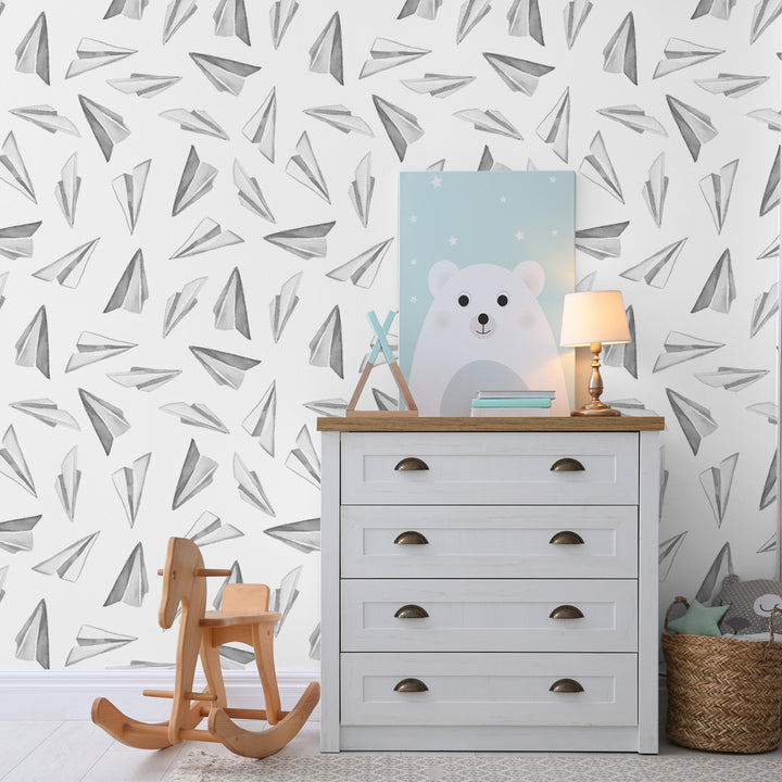 Black and white paper airplane wallpaper featuring hand-painted watercolor airplane illustrations on a white backdrop, available as peel and stick or pre-pasted removable wallpaper.