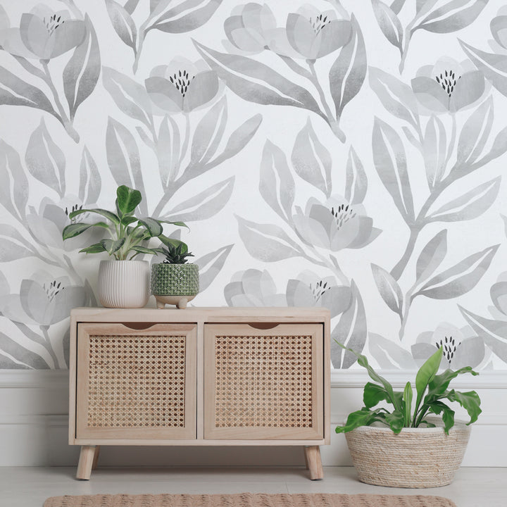 Neutral grey botanical wallpaper with hand-painted flowers and layered leafy stems, removable and renter-friendly in both peel-and-stick and pre-pasted options.