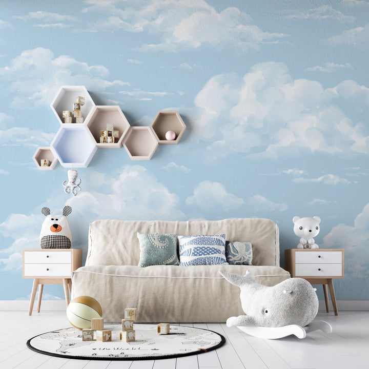 Removable cloud wallpaper showing soft, airy white clouds drifting on a sky-blue background, perfect for kids rooms, nurseries, and playrooms; peel and stick or pre-pasted options.