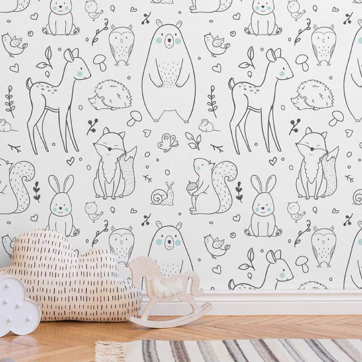 Adorable woodland animals wallpaper featuring hand-drawn bears, foxes, deer, bunnies, and hedgehogs with blush accents on white background, perfect for nursery or kids’ room décor, available in peel-and-stick or pre-pasted removable options.