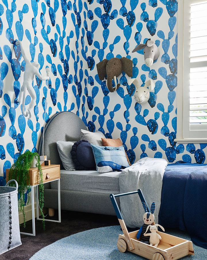 Blue prickly pear cactus pattern wallpaper with a watercolor painted effect, perfect for a fun boys’ room, nursery, or play space. Printed using non-toxic inks on removable, eco-friendly peel-and-stick or pre-pasted wallpaper materials.