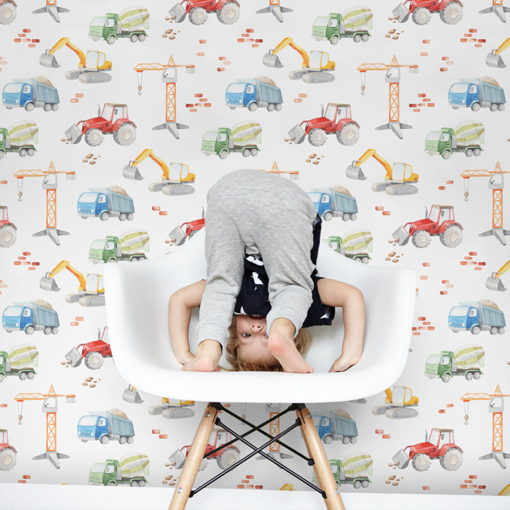 Construction truck wallpaper with watercolor tractors, cement mixers and diggers in a repeating pattern, ideal for toddler bedrooms, playrooms or nurseries, removable without damage.