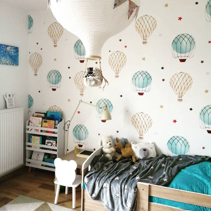 Kids hot air balloon wall pattern in watercolor style with blue and neutral balloons and tiny stars, designed for nurseries and playrooms, removable and damage-free.