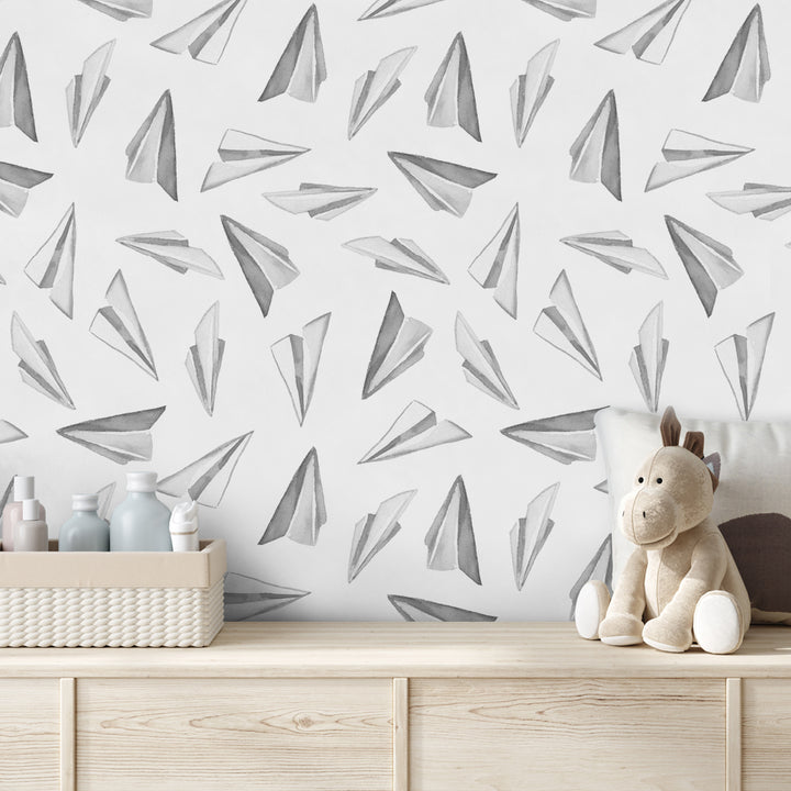 Black and white kids wallpaper with watercolor paper airplane pattern in a repeating layout, printed on removable peel and stick or pre-pasted material.