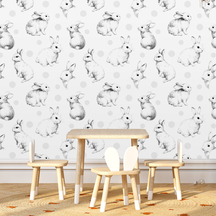 Bunny nursery wallpaper with illustrated rabbits and soft gray polka dots, available in peel-and-stick or pre-pasted options, removable and safe for walls.