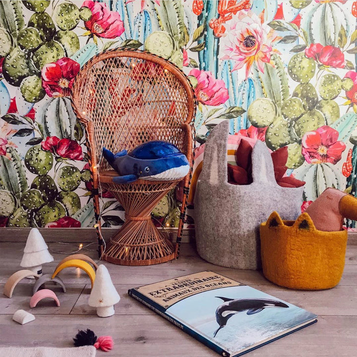 Desert botanical wallpaper featuring watercolor cacti and blooms in pink and coral tones, available in peel-and-stick or pre-pasted removable options.