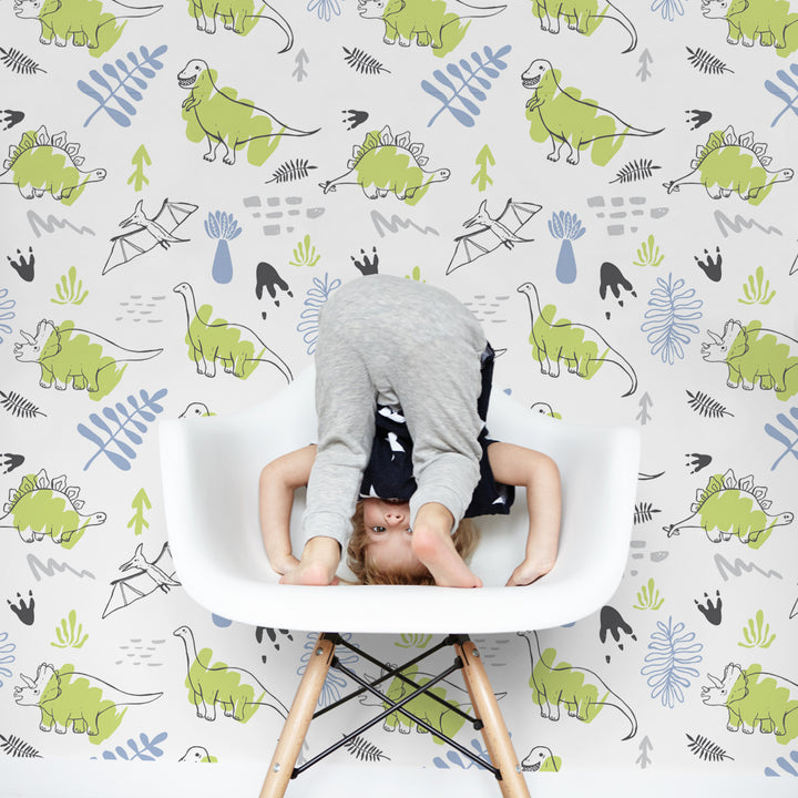 Boys dinosaur wallpaper design with green watercolor dinos and leafy accents, ideal for nurseries or play spaces, available in peel-and-stick or pre-pasted.