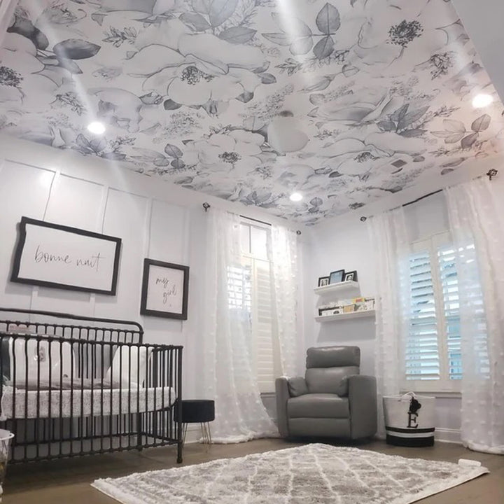 Monochrome botanical floral wallpaper featuring large charcoal grey flowers on a white background, printed on peel and stick or pre-pasted removable wallpaper ideal for bedrooms and nursery decor.