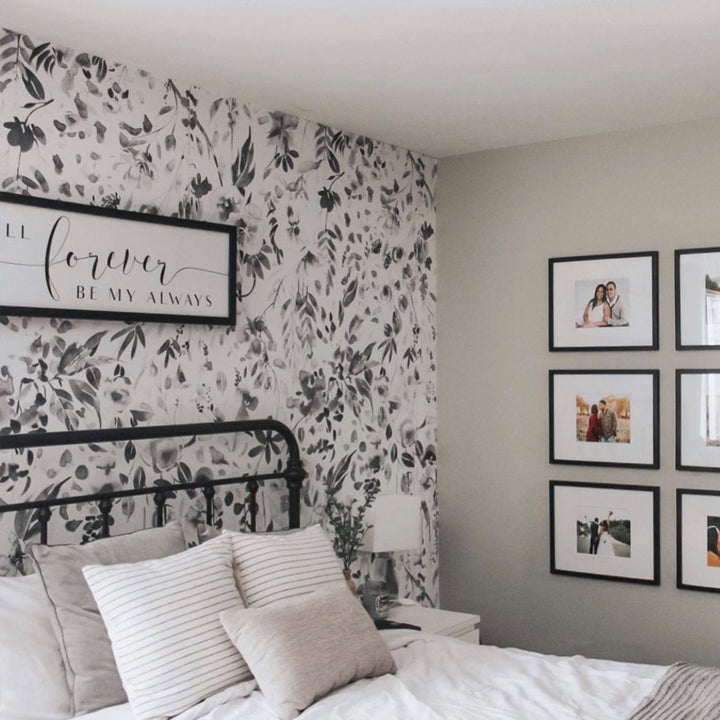 Watercolor wildflower wallpaper in shades of grey and white with detailed leaves and petals, printed on removable peel and stick or pre-pasted wallpaper panels.