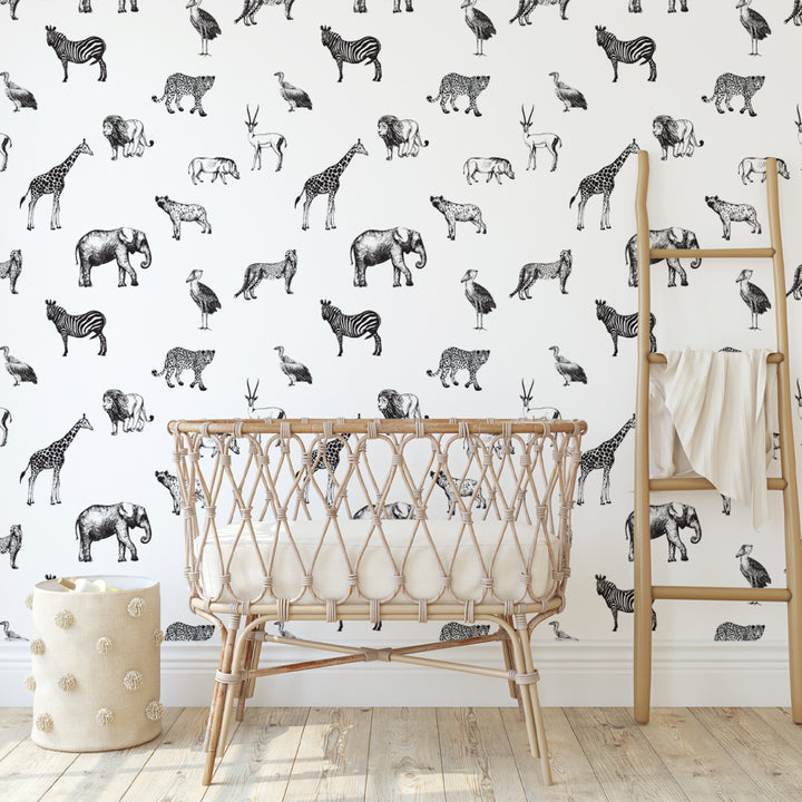 Black and white safari wallpaper featuring hand-drawn zebras, giraffes, elephants, and lions, ideal for modern nurseries or kids’ rooms, available in peel-and-stick or pre-pasted removable materials for easy wall installation.