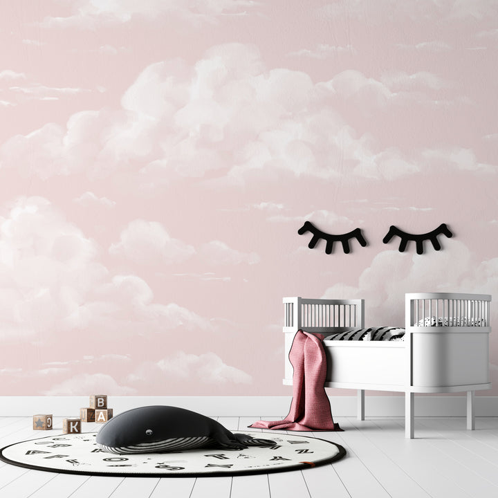 Removable pink cloud wallpaper showing airy white clouds floating on a soft blush background, ideal for girl nurseries, playrooms, or calming kids spaces.
