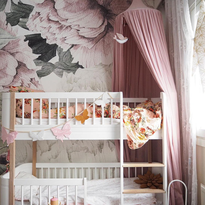 Watercolor peony wallpaper with oversized blush pink flowers and leaves, designed for removable nursery wall décor, available in peel and stick or pre-pasted materials for effortless installation.