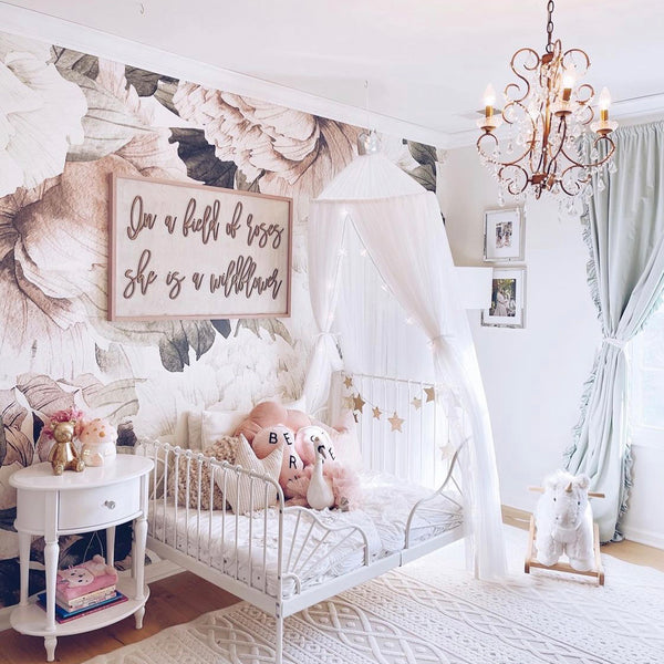 Soft blush pink oversized peony floral wallpaper mural with watercolor style leaves, printed on peel and stick or pre-pasted removable wallpaper, ideal for nurseries, bedrooms, or feature walls.