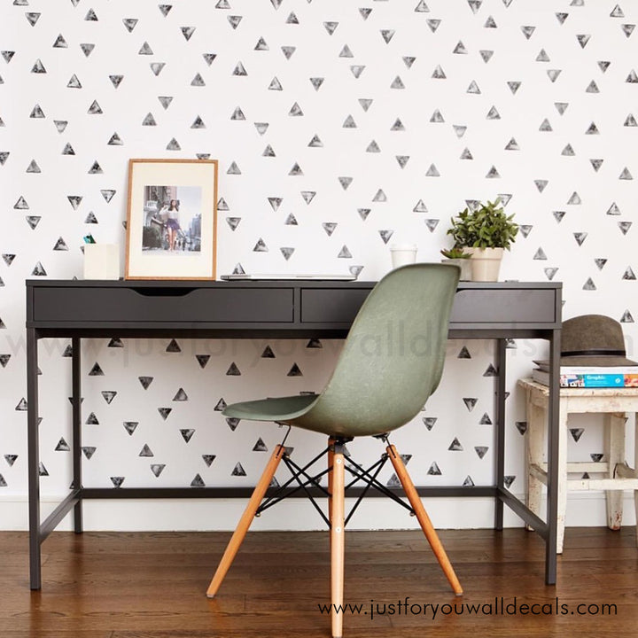 Contemporary geometric wallpaper design with small, modern black triangles in a random pattern., black and white wallpaper