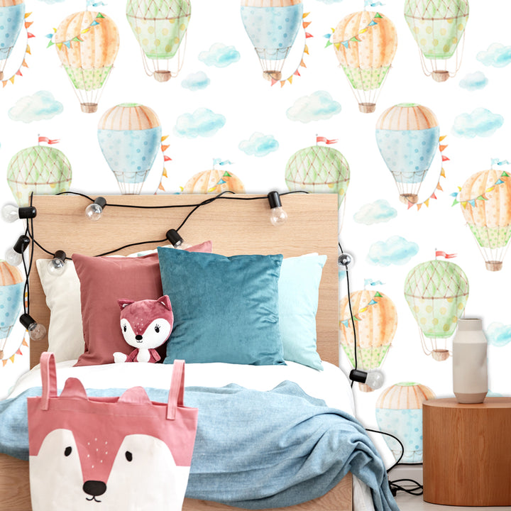 Gender neutral hot air balloon wallpaper featuring whimsical painted balloons floating in the sky, ideal for baby nurseries and children’s bedroom walls.
