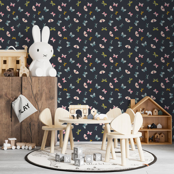 Dark butterfly and dragonfly wallpaper featuring watercolor insects in pink, teal, and green tones on a navy background, perfect for nursery or kids’ bedroom walls.