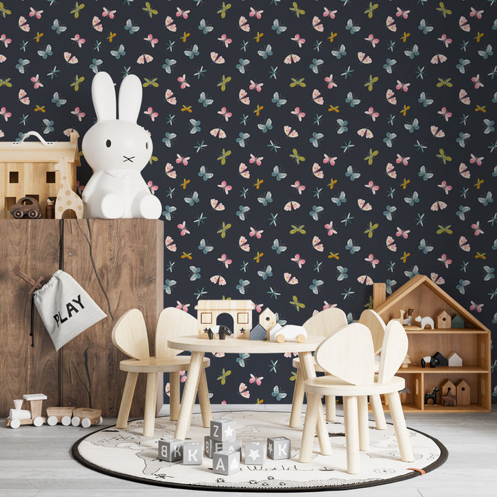 Dark butterfly and dragonfly wallpaper featuring watercolor insects in pink, teal, and green tones on a navy background, perfect for nursery or kids’ bedroom walls.