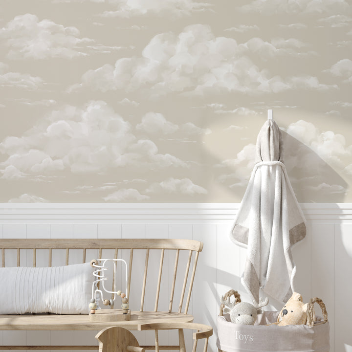 Beige cloud wallpaper with fluffy, hand-painted clouds drifting across a muted sky, offered as peel and stick or pre-pasted removable wallpaper.