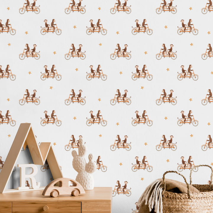 Whimsical monkey cycling wallpaper pattern in warm brown and orange tones on white, perfect for playful children’s rooms or animal-themed nursery decor.