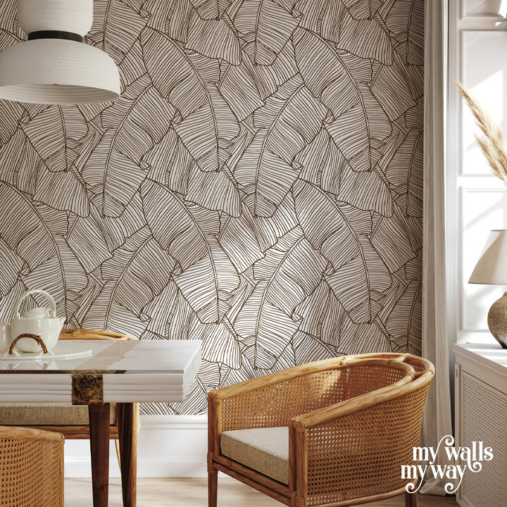 Modern line art wallpaper featuring overlapping palm leaves in neutral tones, available in peel-and-stick or pre-pasted removable options, perfect for boho interiors.