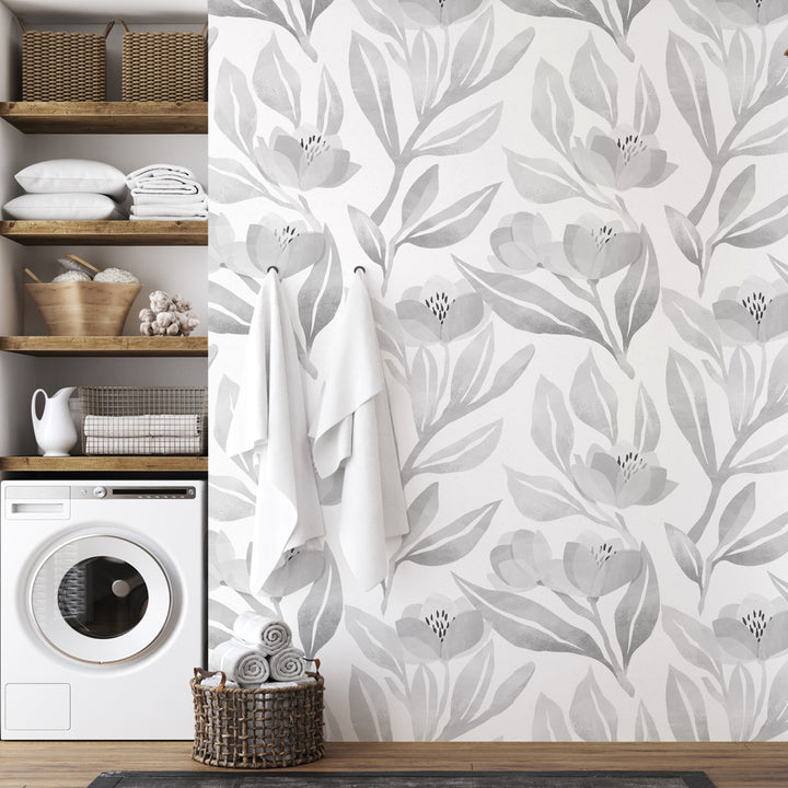Soft grey floral watercolor wallpaper with hand-painted leaves and petals, designed in a calm neutral palette for bedrooms, nurseries, and modern minimalist interiors.