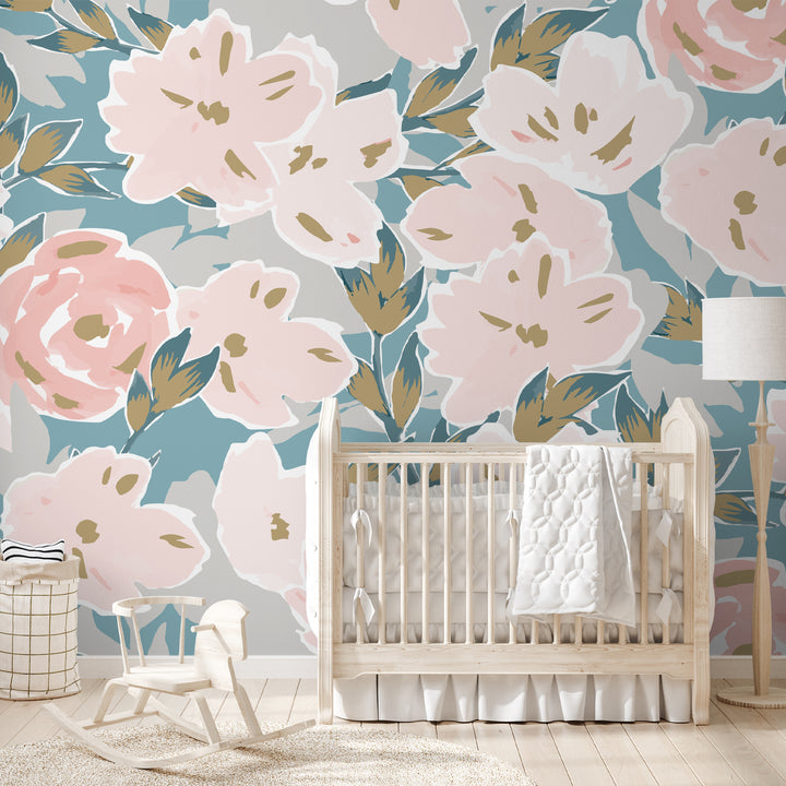 Oversized blush pink floral wallpaper with teal and sage green leaves on a neutral background