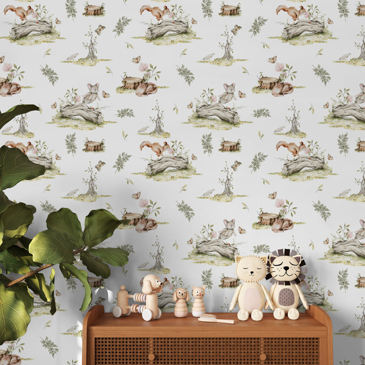 Storybook woodland wallpaper with illustrated squirrels, rabbits, deer, and forest plants arranged in a repeating toile pattern, ideal for nurseries and kids bedrooms.