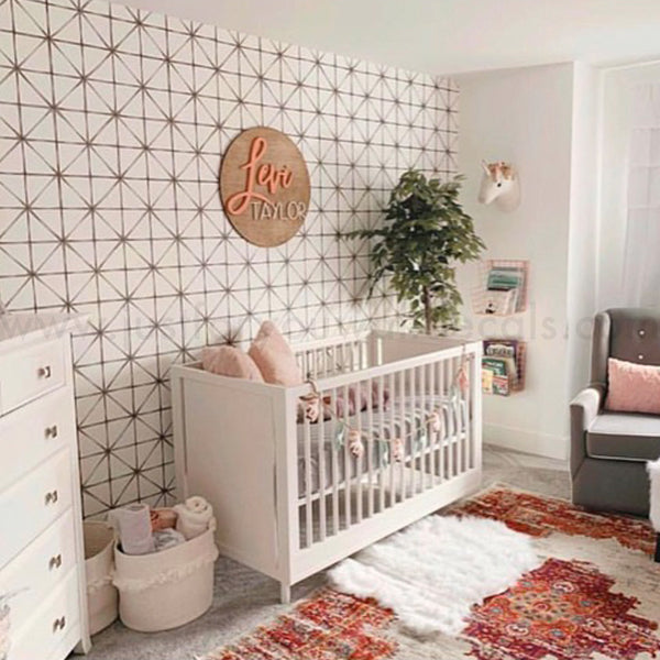 Modern geometric wallpaper featuring symmetrical diamond patterns in soft neutral colors.