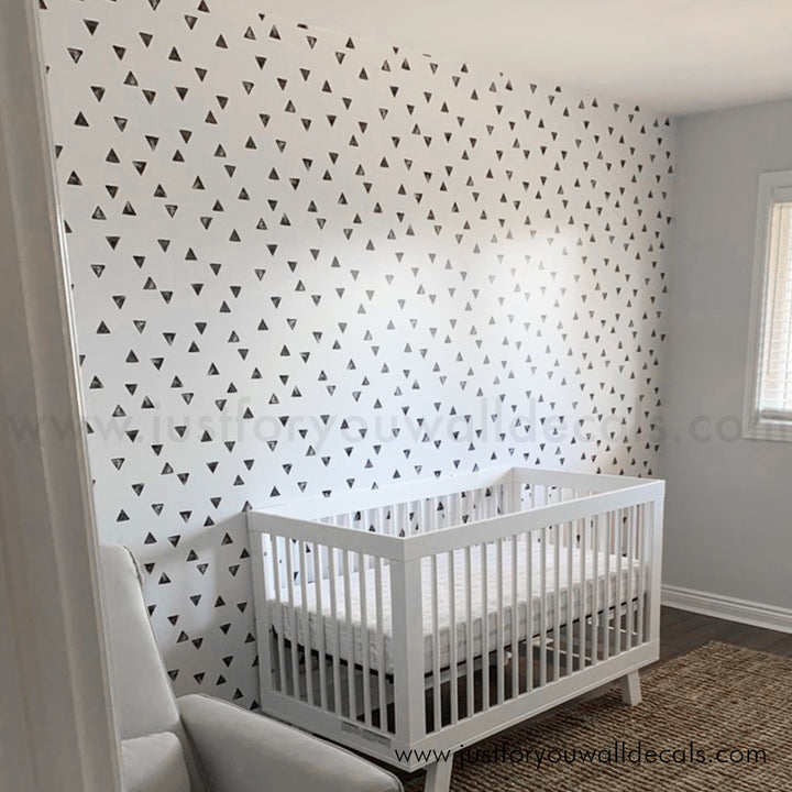 Minimalist wallpaper featuring scattered black triangles on a clean white background, black and white nursery wallpaper