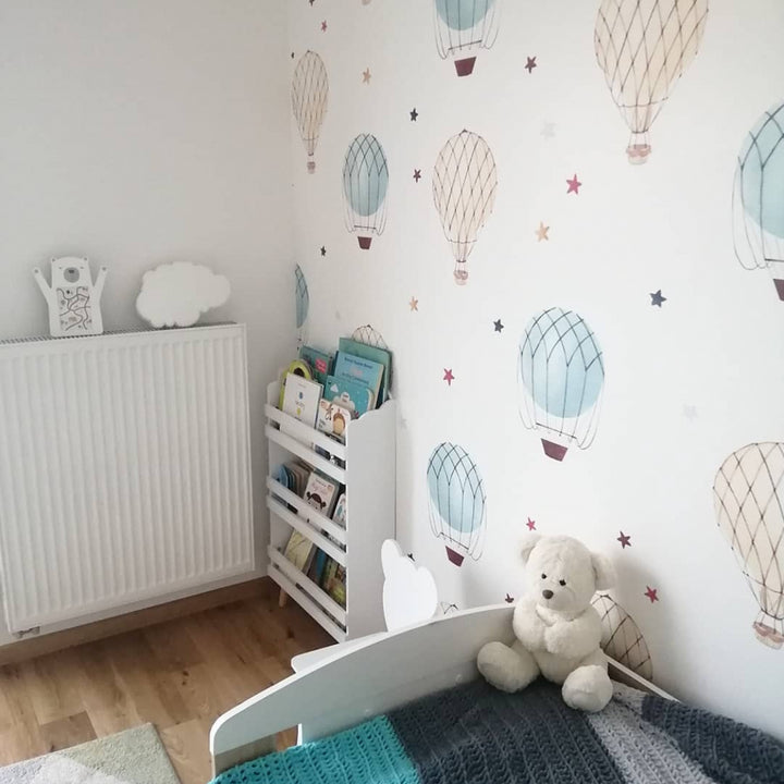 Pastel balloon wallpaper with hand-painted illustration style and airy spacing, modern nursery wallpaper available as peel and stick or pre-pasted removable.