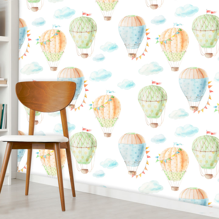 Removable nursery wallpaper with hand-painted hot air balloons in blue, peach and green tones, printed on peel and stick or pre-pasted material.
