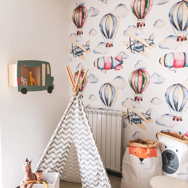 Blue and pink balloon wallpaper with watercolor clouds and retro planes for children’s rooms, printed on matte removable wallpaper for easy installation.