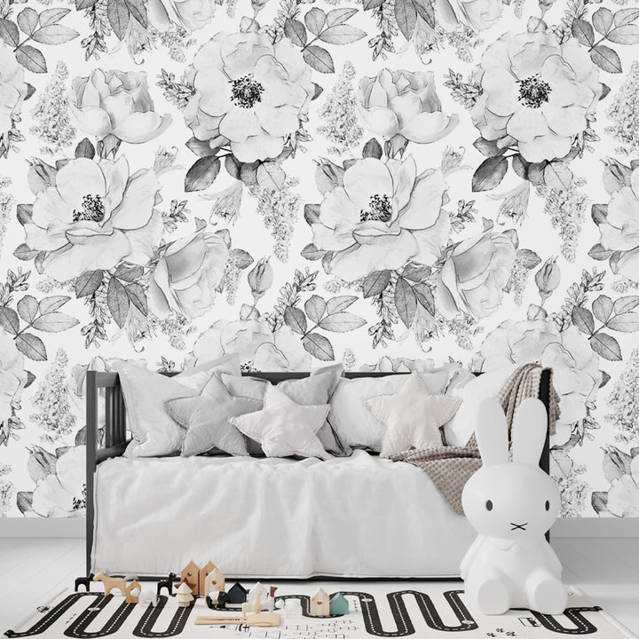 Black and white botanical mural wallpaper featuring watercolor-style florals and leaves, offered in removable peel and stick or pre-pasted installation for nurseries, bedrooms, and ceilings.