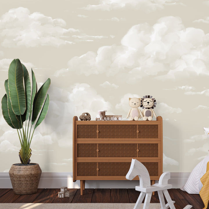 Neutral nursery cloud wallpaper with soft, fluffy clouds on a warm sky background, printed on peel and stick or pre-pasted removable wallpaper.