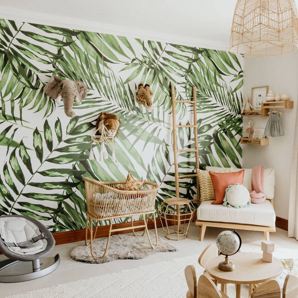 Leafy tropical nursery wallpaper featuring large watercolor palm fronds in soft greens on white, removable without damage and available in multiple materials.