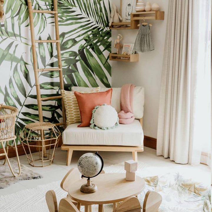 Green tropical palm leaf wallpaper that brightens a nursery or playroom, offering easy DIY peel and stick or pre-pasted installation and clean removability.