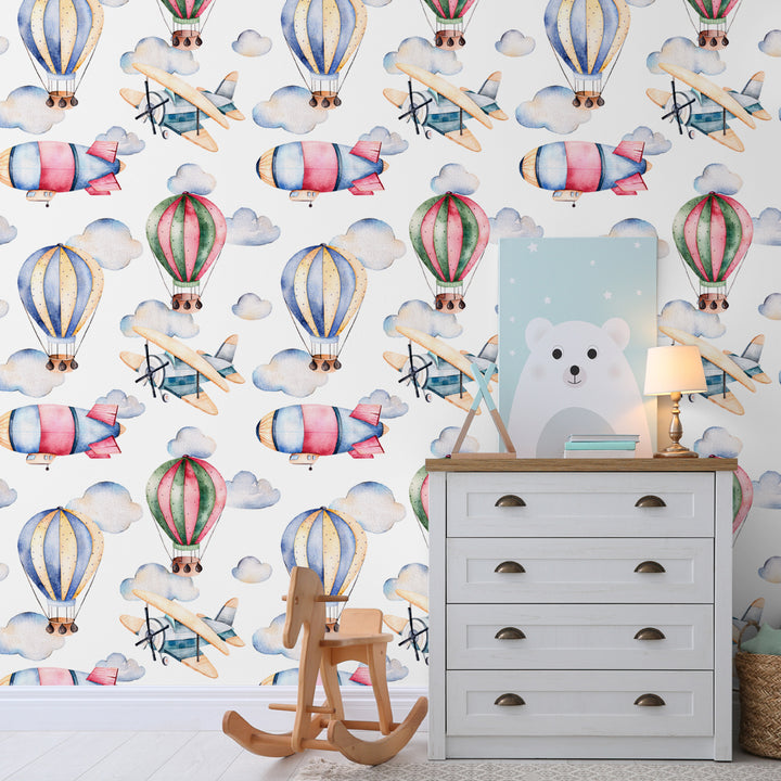 Gender-neutral hot air balloon wallpaper with playful aviation theme in soft pastel colors, ideal for nurseries or kids’ bedrooms, available in peel and stick.