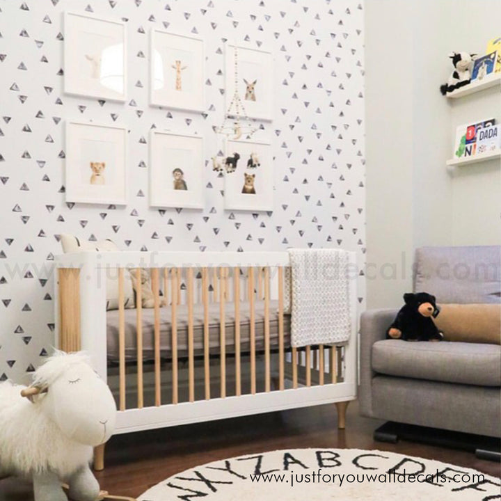 Minimalist wallpaper featuring scattered black triangles on a clean white background, nursery wallpaper