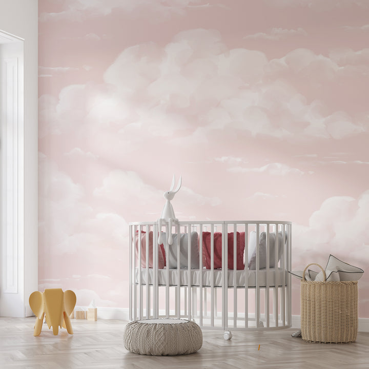 Dreamy blush cloud wallpaper with soft, airy white clouds on a pink sky, printed on removable peel and stick or pre-pasted material for simple installation.