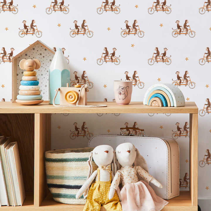 Playful monkeys riding bicycles wallpaper for kids’ bedrooms or playrooms, removable and eco-friendly with Peel & Stick or Pre-Pasted options for easy installation.
