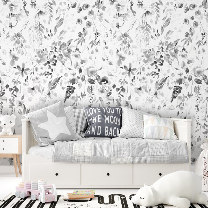 Elegant grey wildflower wallpaper with soft watercolor strokes, floating petals, and natural botanical motifs for minimalist or gender-neutral nursery décor.