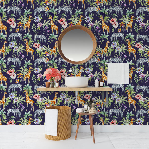 Tropical animal wallpaper featuring giraffes, zebras, and lush green palm leaves on a navy blue background, with pink and purple tropical flowers, available in peel and stick or pre-pasted removable options.