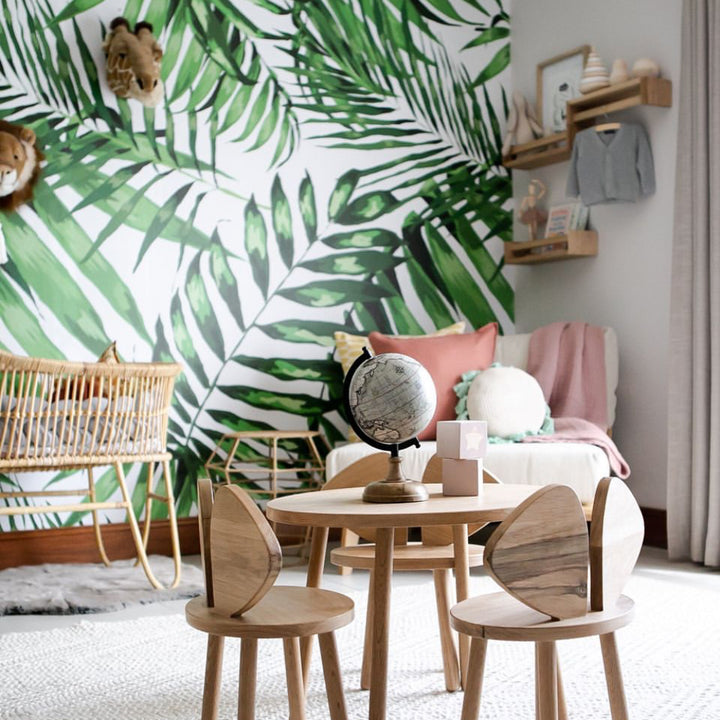 Tropical botanical wallpaper with bold overlapping palm leaves, removable peel and stick or pre-pasted design, ideal for bedrooms or offices.