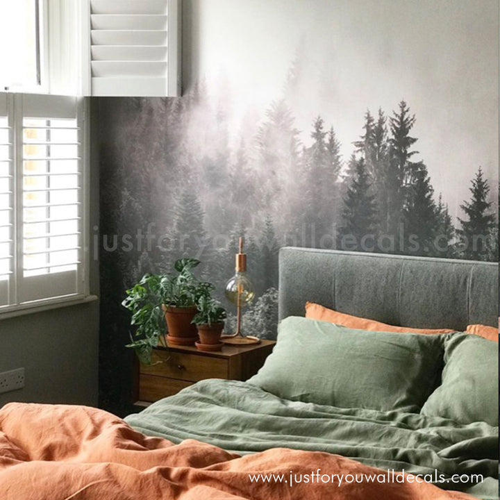Realistic forest scene wallpaper featuring tall evergreen trees in a dreamy, atmospheric mist.