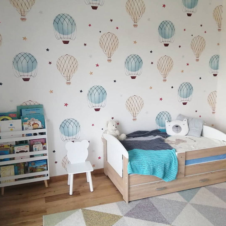 Whimsical hot air balloon wallpaper featuring watercolor balloons and stars floating across a white background, ideal for boy or girl nurseries, renter-friendly installation.
